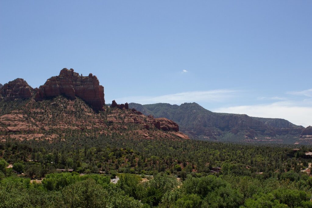 Red rock buttes rising above green desert scrub in Arizona
