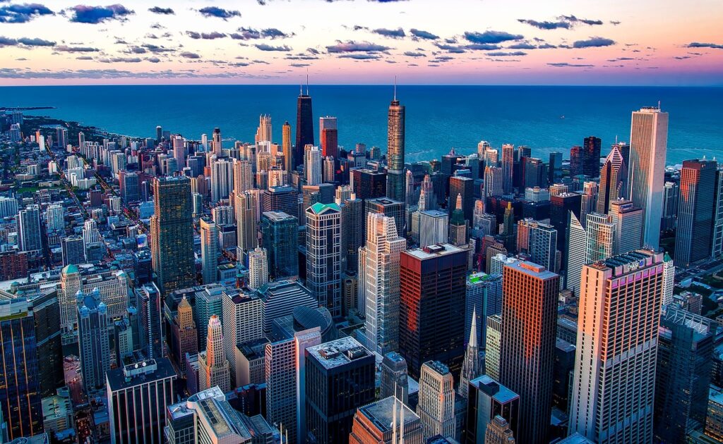 Aerial view of downtown Chicago's towers at dusk with Lake Michigan behind them